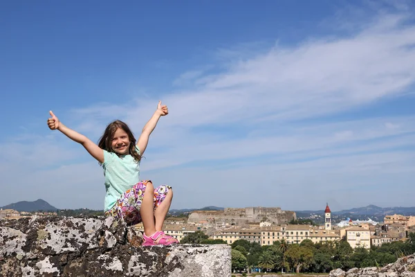 Happy little girl with thumbs up in Corfu town Greece — Stock Photo, Image