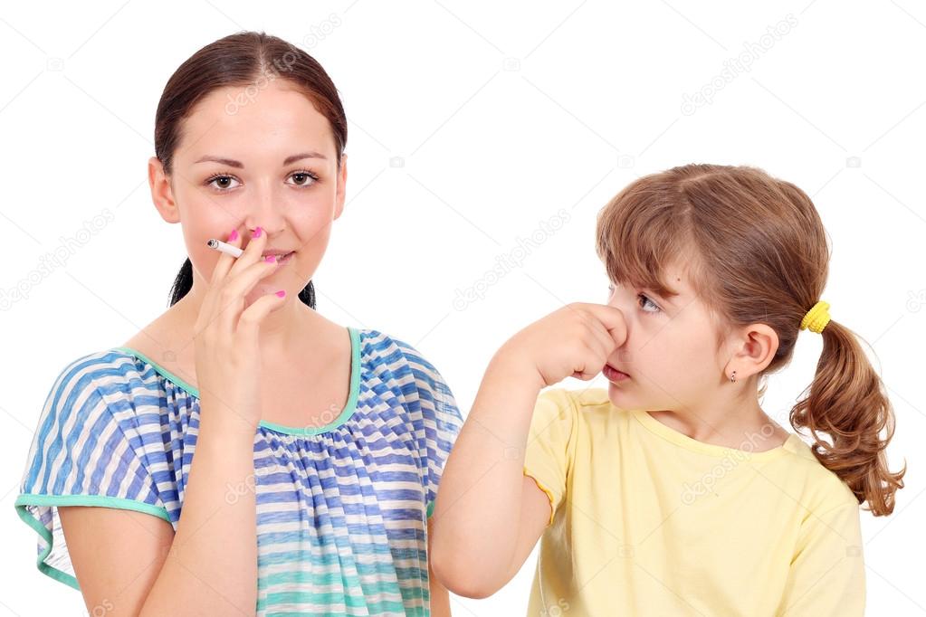 little girl bothered by tobacco smoke
