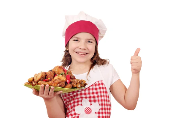 Heureux petite fille cuisinier avec poulet pilon et pouce vers le haut — Photo