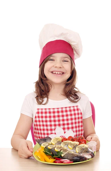 Happy little girl cook with trout fish — Stock Photo, Image