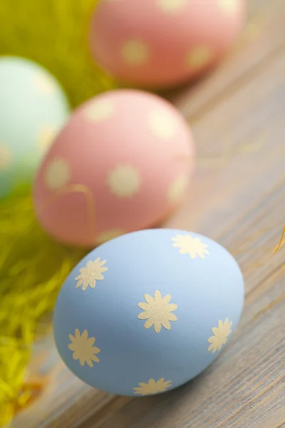 Colorful painted Easter eggs on wooden table — Stock Photo, Image