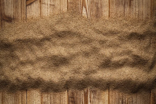 Sand on wooden table