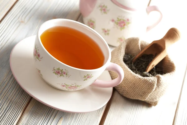 Tasse Tee, Teekanne und getrocknete Teeblätter im Beutel — Stockfoto