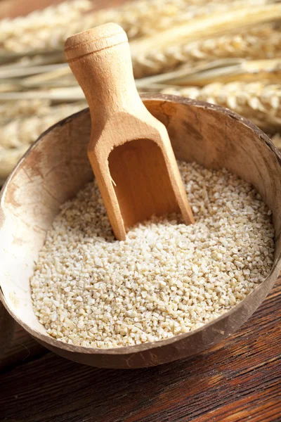 Buckwheat in bowl on wooden table — Stock Photo, Image