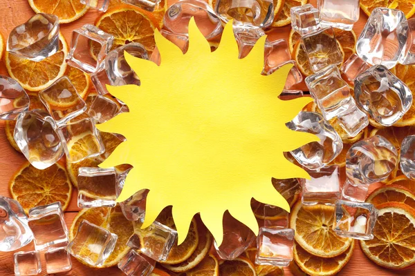 Shape of sun cut out of paper and ice cubes — Stock Photo, Image