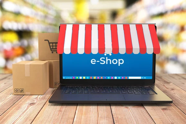 Laptop Warenkorb Und Versandboxen Auf Tisch Und Shop Interieur Hintergrund Stockfoto