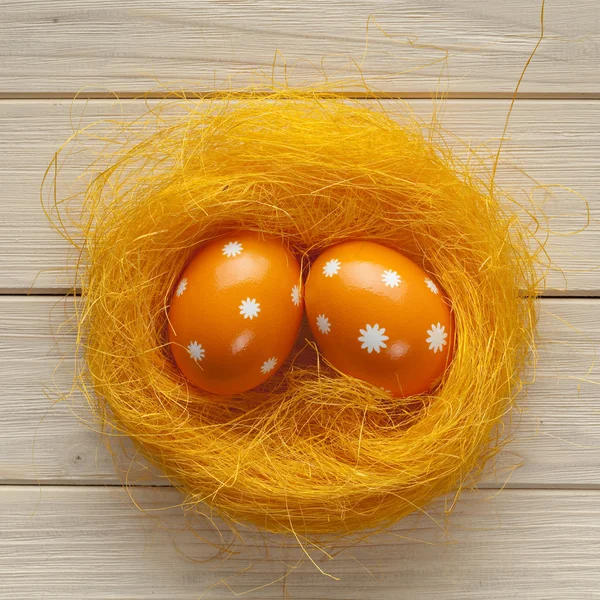 Orange Easter eggs in the nest — Stock Photo, Image