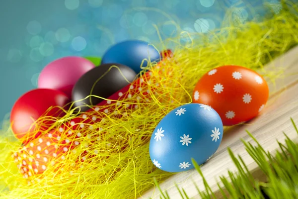 Colored Easter eggs on blue sky background — Stock Photo, Image