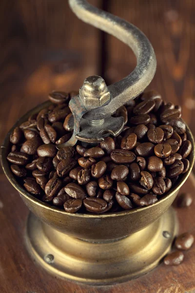 Coffee grains in old coffee grinder — Stock Photo, Image