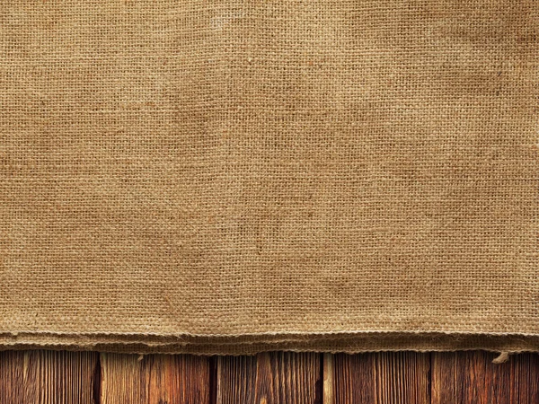 Creased fabric on wooden wall background — Stock Photo, Image