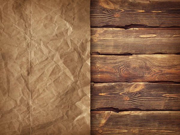 Creased handmade paper on wooden wall background — Stock Photo, Image