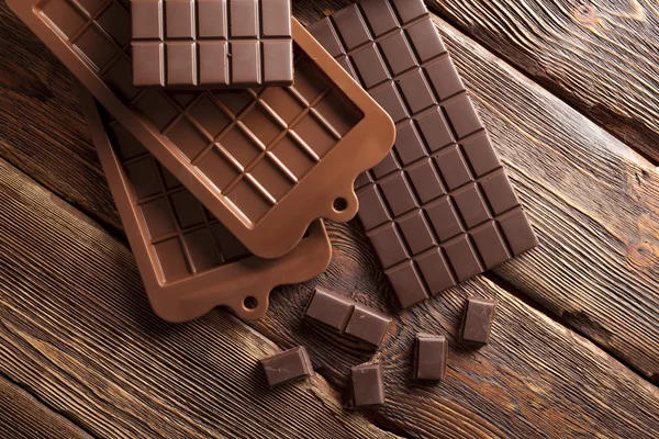 Chocolate on wooden wall background — Stock Photo, Image