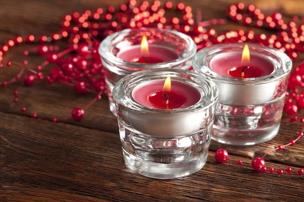 Christmas candles on wooden planks background — Stock Photo, Image