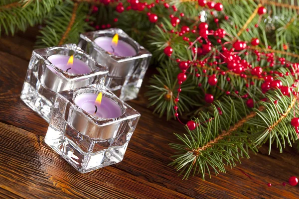 Three christmas candles and branch of xmas tree — Stock Photo, Image