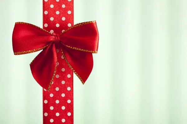 Red bow and ribbon on abstract background — Stock Photo, Image