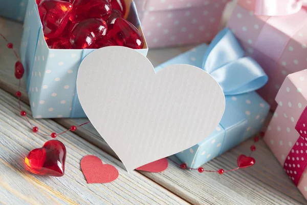 Shape of hearts and colored gift boxes — Stock Photo, Image