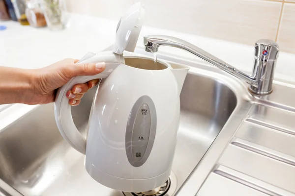 Pouring water into an electric kettle — Stock Photo, Image