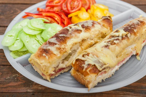 Tasty sandwich with ham, melted cheese and vegetables — Stock Image Tasty sandwich with ham, melted cheese and vegetables Stock Image