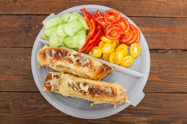 Tasty sandwich with ham, melted cheese and vegetables — Stock Image Tasty sandwich with ham, melted cheese and vegetables Stock Photo
