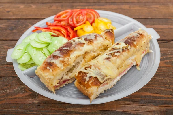 Tasty sandwich with ham, melted cheese and vegetables — Stock Photo, Image
