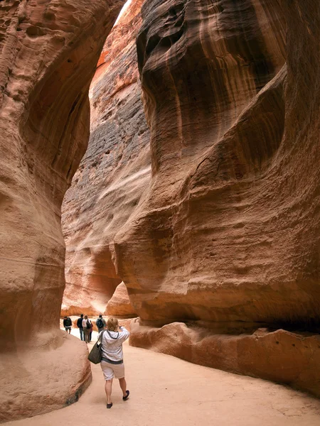 Turistas caminham através do Siq para a antiga cidade de Petra, Jord — Fotografia de Stock
