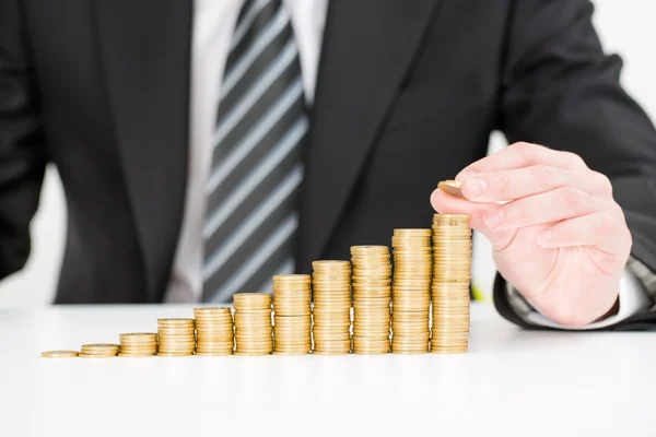 Zakenman hand zetten geld munt stapel groei van bedrijf. — Stockfoto