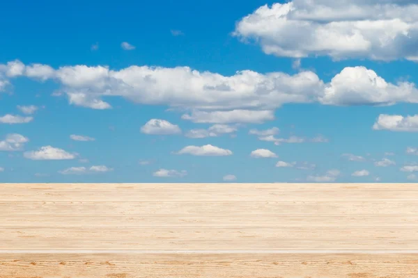 Cloudy blue sky and wood floor — Stock Photo, Image