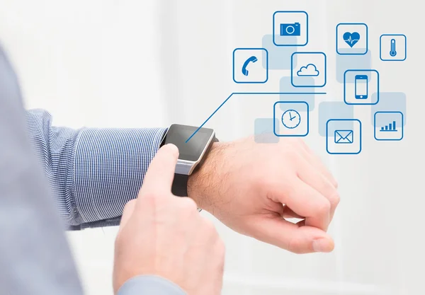 Wearing touchscreen smartwatch with app icons. — Stock Photo, Image