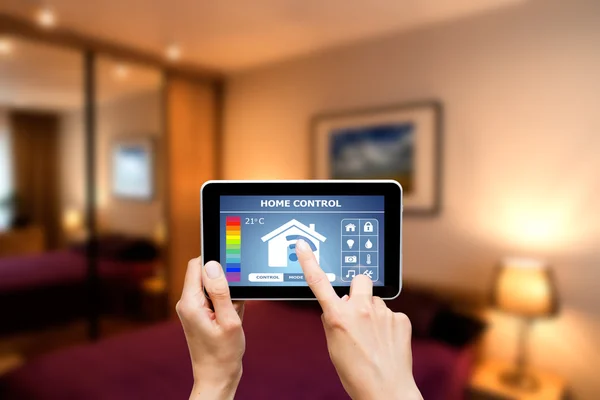 Remote home control system on a digital tablet. — Stock Photo, Image