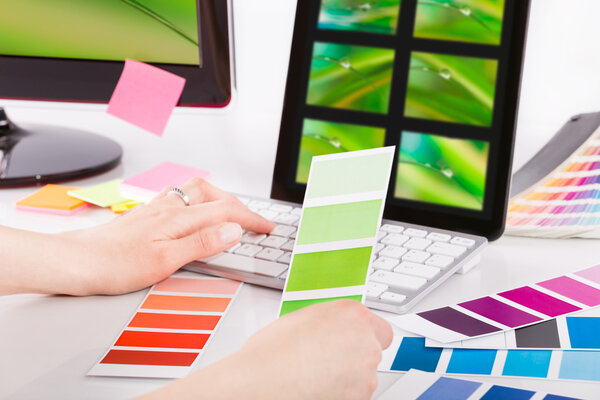 Graphic designer at work. Color samples.