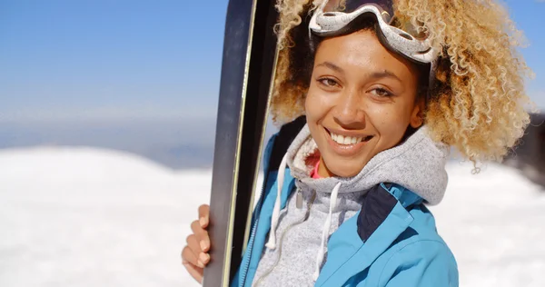 Beautiful woman holding skis — Stock Photo, Image