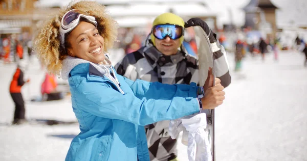 Homem flertando com mulher segurando snowboard — Fotografia de Stock