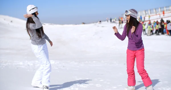 Two women having snow fight — Stockfoto