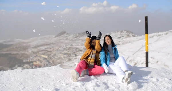 Vrouwen zitten op de bergtop in de sneeuw — Stockfoto