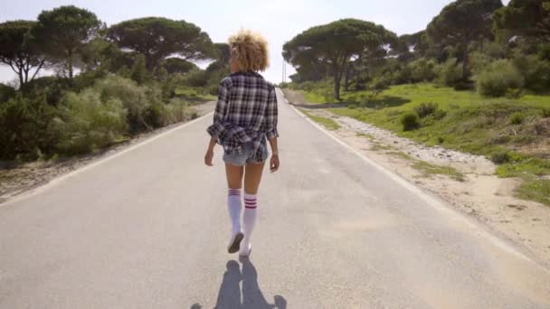 Woman walking alone on road — Stock Video