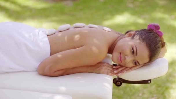Giovane donna rilassata con un fiore tra i capelli — Video Stock