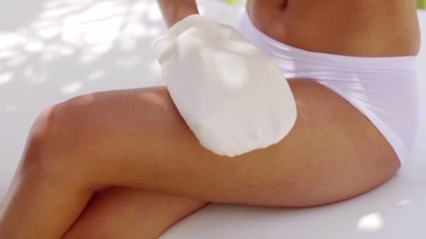 Jovem mulher a polir a pele com uma luva — Vídeo de Stock