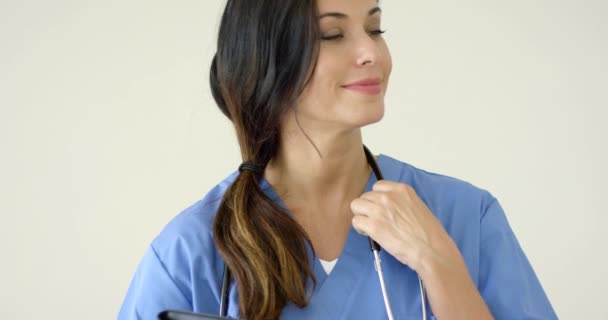 Woman in scrubs holds black portfolio — Stockvideo