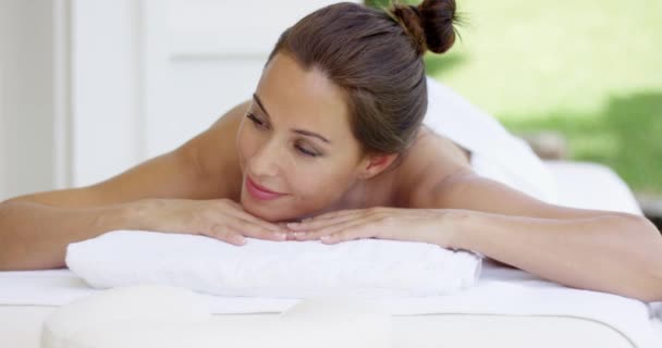 Woman on spa table wrapped in white towels — Stock Video