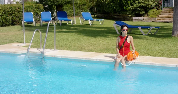 Ναυαγοσώστη μαγιό κάθεται στην άκρη της πισίνας — Φωτογραφία Αρχείου