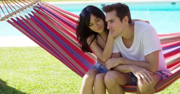 Young couple sitting on hammock — Stock Video