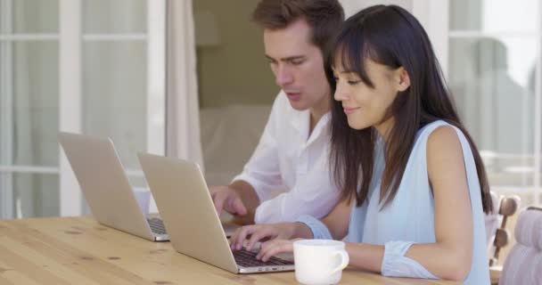 Pareja trabajando en computadoras portátiles juntos — Vídeo de stock