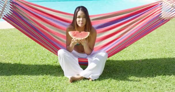 Woman biting into watermelon slice — 图库视频影像