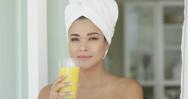 Young woman drinking orange juice — Stock Video