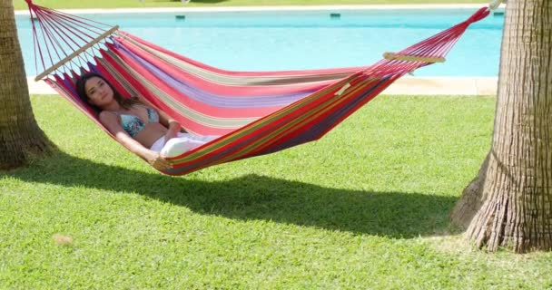 Young woman in colorful hammock — ストック動画