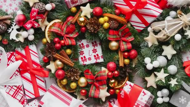 Christmas background theme made with wreaths, colorful wrapped boxed gifts, festive clothes — Stock Video