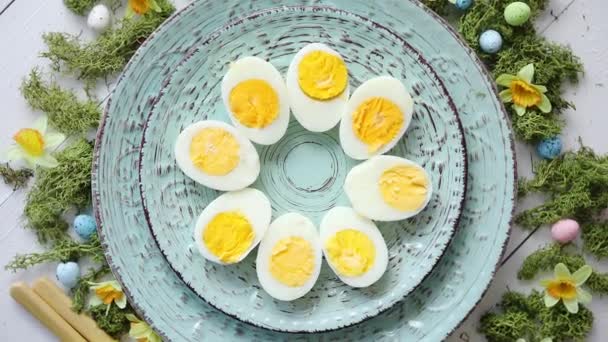Velikonoční prostírání s květinami a vejce. Dekorativní desky s vařenými vejci — Stock video