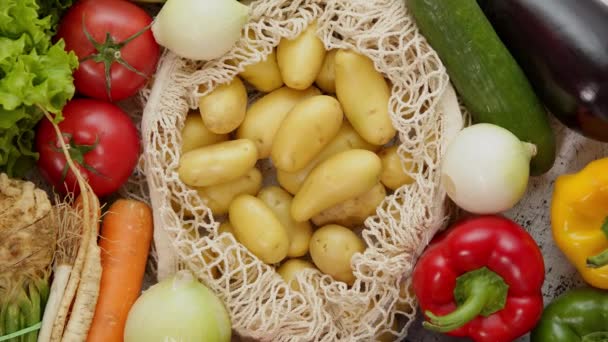 Vegetables in reusable net bags on white scratched background, top view. Zero waste and eco — Stock Video