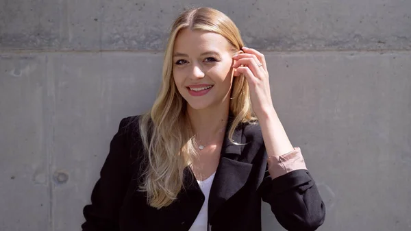 Cheerful female manager adjusting hair — Stock Photo, Image