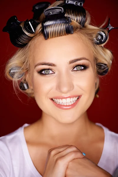 Beautiful blond with her hair in curlers — Stock Photo, Image